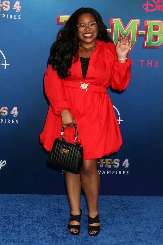 Carla Jeffery smiling as she poses at a red-carpet event