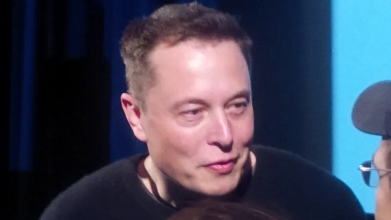 Elon Musk looks toward Donald Trump at a Washington event.