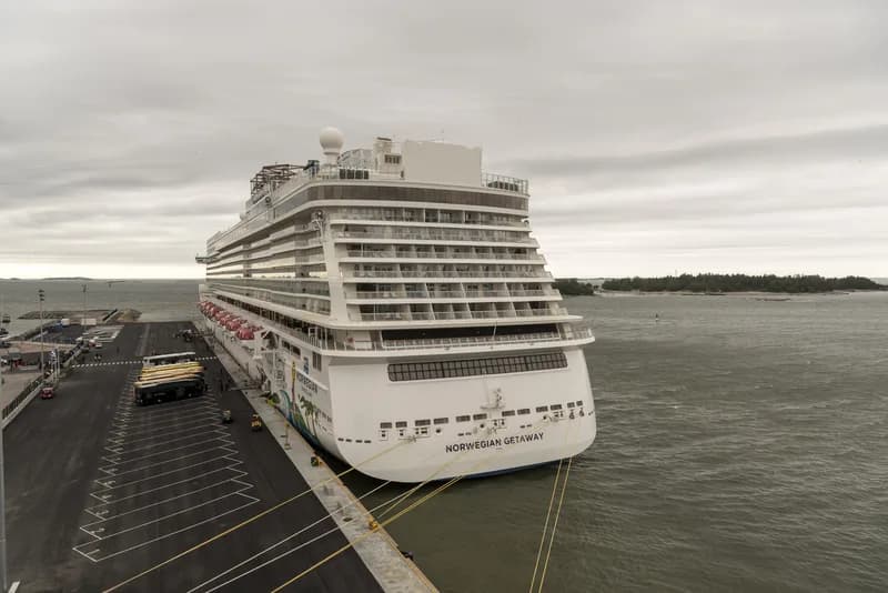 The Norwegian Getaway cruise ship at sea, its rows of balcony staterooms rising above an open promenade deck